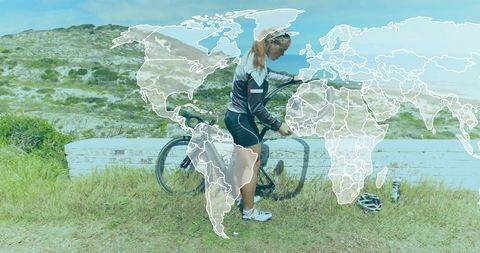 Woman cyclist pumping tire on outdoor bike ride