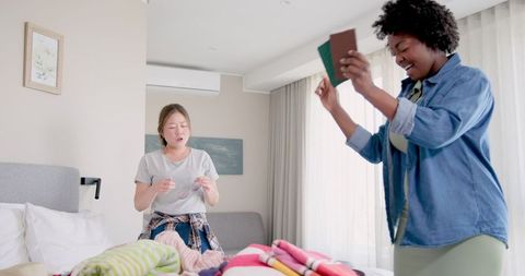 Interracial Couple Joyfully Packing for Summer Vacation