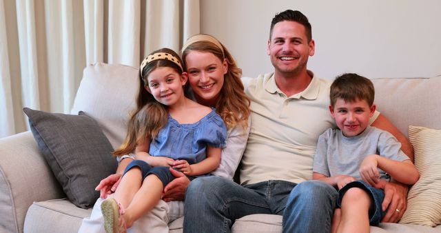 Smiling Family Sitting on Couch Relaxing at Home - Download Free Stock Images Pikwizard.com