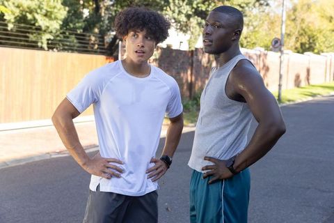 Diverse male friends slightly tired during outdoor workout pause