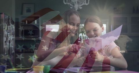 Mother and daughter crafting together in kitchen