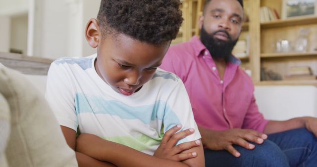 Father Comforting Upset Son Sitting on Couch at Home - Download Free Stock Images Pikwizard.com