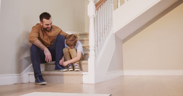 Father Helping Son Tie Shoelaces on Staircase at Home - Download Free Stock Images Pikwizard.com