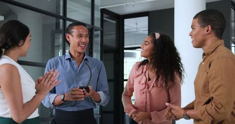 Diverse Colleagues Celebrate Success Rewarding Coworker