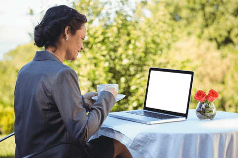 professional woman enjoying coffee with transparent laptop screen - Download Free Stock Videos Pikwizard.com