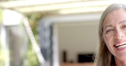 Joyful Senior Woman with Gray Hair Laughing Uncontrollably Outdoors