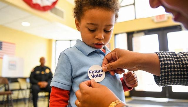 Child receiving future voter sticker at polling place promoting civic engagement and family voting