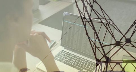 Woman Analyzing Laptop Code with Network Overlay in Office