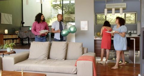 Diverse Friends Preparing for a Housewarming Celebration in Modern Living Room