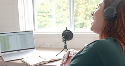 Joyful Woman Podcasting With Laptop and Microphone at Home - Download Free Stock Images Pikwizard.com