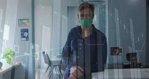 Caucasian Man wearing Face Mask in Office with Financial Data Overlay