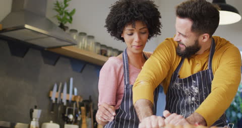 Happy Diverse Couple Enjoys Baking Together in Kitchen