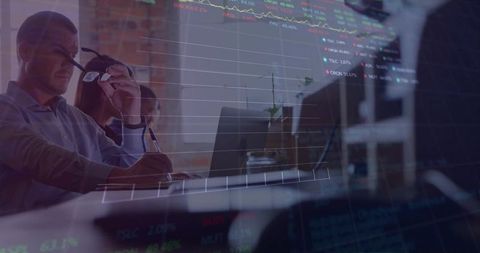 Adjusting executive analyzing financial charts, collaborating with team in modern coworking office