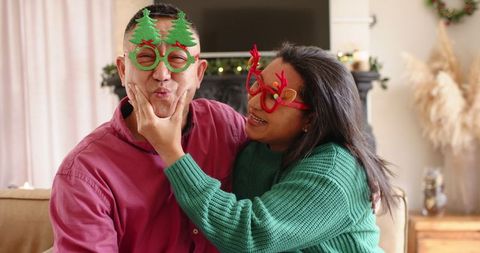Joyful family bonding with festive holiday glasses in living room