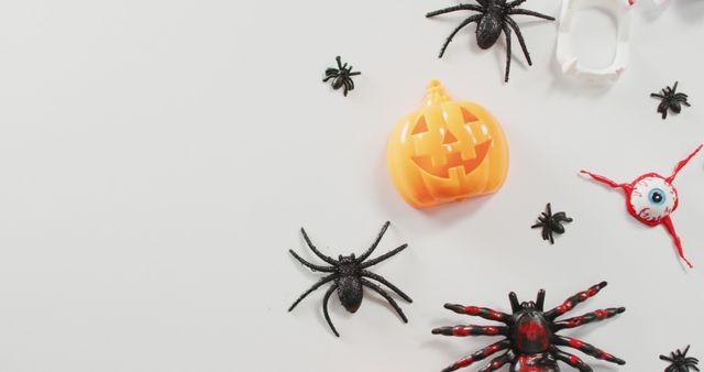 Close up of multiple halloween toys and candies with copy space on white background. halloween festivity and celebration concept