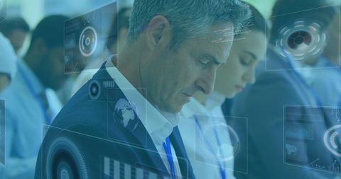 Businesspeople viewing innovative digital technology displays