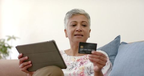 Senior Woman with Credit Card and Tablet for Online Shopping