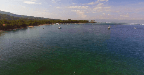 transparent blue sea under open sky scenic coastal view - Download Free Stock Videos Pikwizard.com