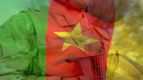 Cameroon Flag Overlay on Soldier in Uniform with Weapon