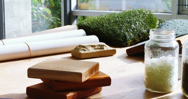 Desk with Wood Samples, Plans, Jar and Grass Turf in Natural Light - Download Free Stock Images Pikwizard.com