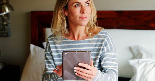 Relaxed Woman in Pajamas Using Tablet on Bed - Download Free Stock Images Pikwizard.com