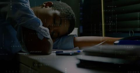 Woman resting on desk during late-night work with binary code overlay and moody lighting