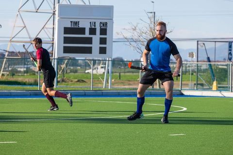 Male Field Hockey Players on Synthetic Turf in Action