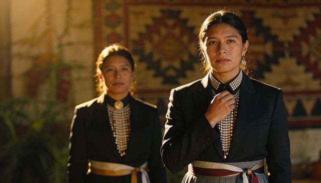 Ceremonial portrait of women wearing beaded bib necklaces, sashes and woven textiles