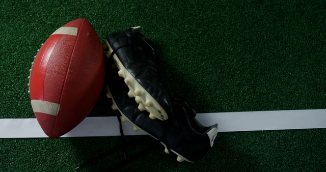 Football and Cleats on Green Turf - Download Free Stock Images Pikwizard.com