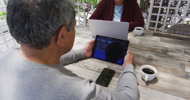 Seniors Using Technology Devices Outdoors with Coffee - Download Free Stock Images Pikwizard.com