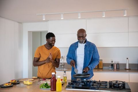 Father and Son Cooking Breakfast Together in Home Kitchen