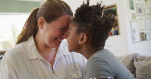 Laughing Mother and Daughter in Bright Living Room