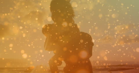 Silhouette Couple Piggyback Ride on Sunset Beach with Bokeh Light Effects