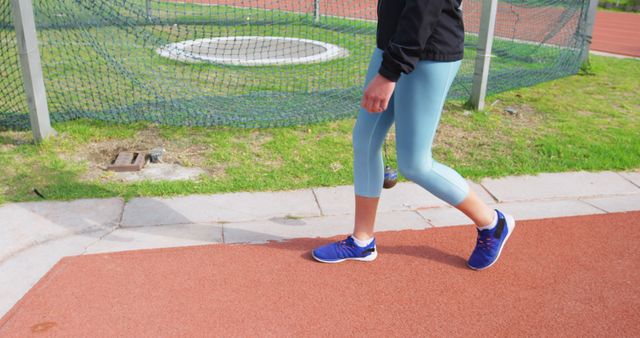 Caucasian girl jogging on a track, with copy space. Outdoor exercise promotes a healthy lifestyle and physical fitness.
