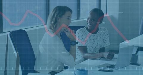 Female Coworkers Analyzing Data with Digital Overlay