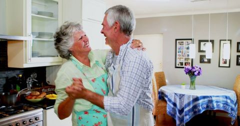 Senior Couple Dancing in Kitchen Sharing Joyful Moment - Download Free Stock Images Pikwizard.com