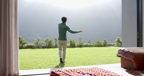Person Enjoying Tranquil Outdoor View from Modern Home