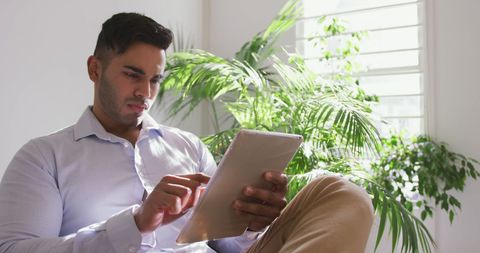 Professional Man Using Tablet in Bright Office Environment