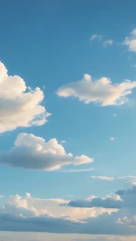 Drifting cumulus clouds rolling across blue sky vertical video for calming backgrounds