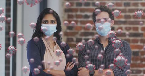Masked professionals surrounded by 3d covid-19 virus graphics