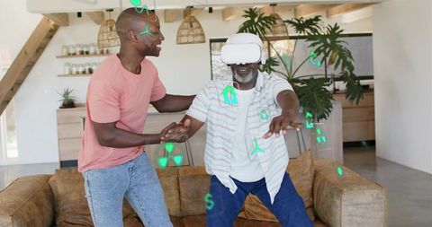 Senior Experiencing Virtual Reality while Adult Guiding on Living Room Couch, Holographic UI
