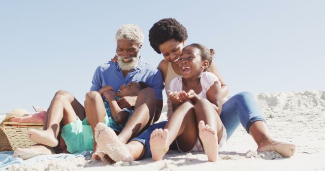 Happy african american couple embracing with children on sunny beach. healthy and active time beach holiday.