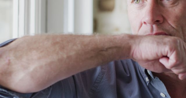 Man Protecting Others from Germs by Coughing into Elbow Indoors - Download Free Stock Images Pikwizard.com