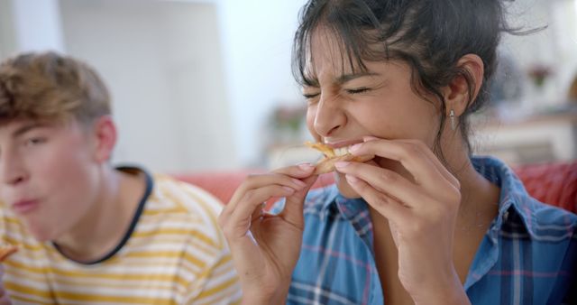 Friends Enjoying Fries and Laughing Together Indoor - Download Free Stock Images Pikwizard.com