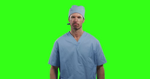 Image of a male surgeon wearing blue scrubs and a matching surgical cap. The green screen background can be easily edited or replaced. Suitable for use in medical presentations, healthcare advertisements, or educational materials about the medical field.