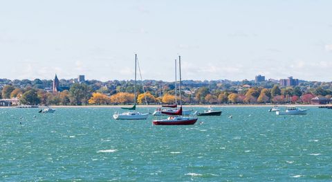Sailboats anchored in panoramic harbor view