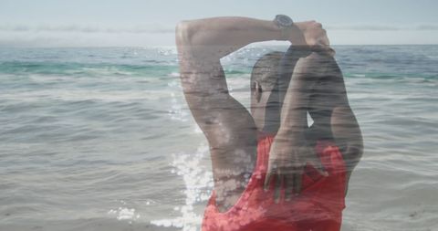 Double Exposure of Ocean and Stretching African American Man