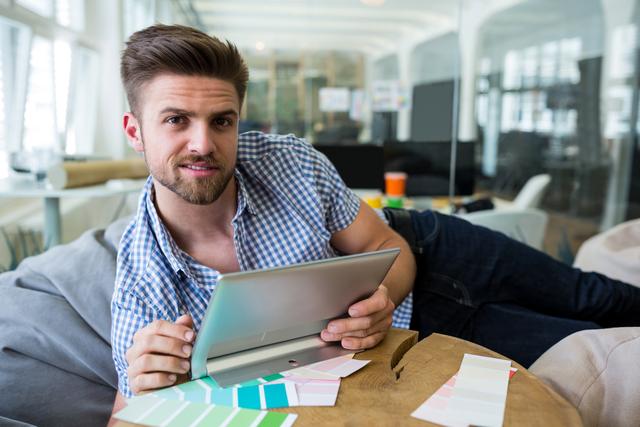 Male graphic designer using digital tablet in office 4k