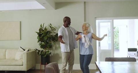 Senior Couple Dancing Joyfully in Bright Living Room Retreat