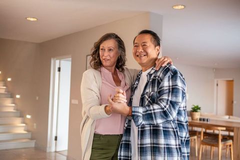 Senior Couple Dancing Gracefully at Home with Romantic Atmosphere